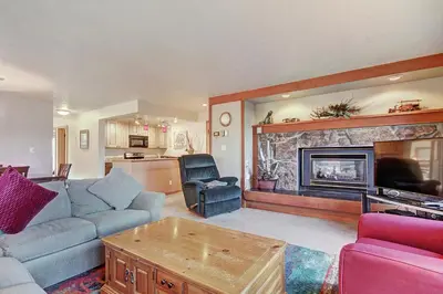 a living room with a couch and a fireplace at 2019 Lodgepole Condo in Keystone