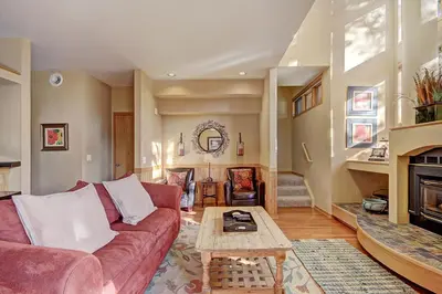 a living room with a red couch and a coffee table at 1926 Soda Springs Ii Townhouse in Keystone