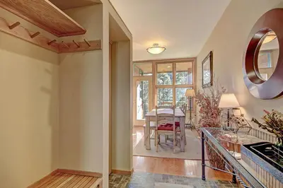 a kitchen and living room with a table and a mirror at 1926 Soda Springs Ii Townhouse in Keystone