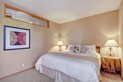 a bedroom with a large bed and two lamps at 1926 Soda Springs Ii Townhouse in Keystone