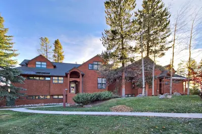 a large brick house with a driveway at 1926 Soda Springs Ii Townhouse in Keystone