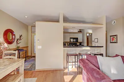 a living room with a couch and a table at 1926 Soda Springs Ii Townhouse in Keystone