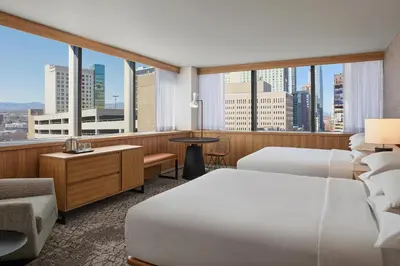 a hotel room with two beds and a large window at Sheraton Denver Downtown Hotel in Denver