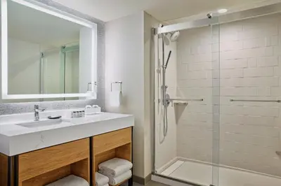 a bathroom with a sink and a shower at Sheraton Denver Downtown Hotel in Denver