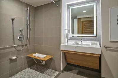 a bathroom with a sink and a shower and a mirror at Sheraton Denver Downtown Hotel in Denver