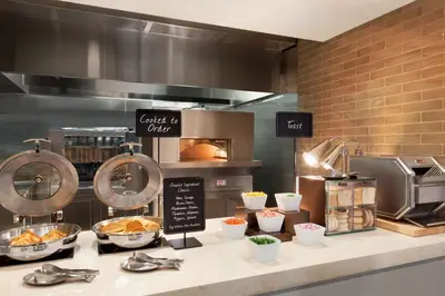 a kitchen with a counter with some food on it at Embassy Suites By Hilton Boulder in Boulder