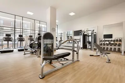 a gym with several treadmills and cardio machines at Embassy Suites By Hilton Boulder in Boulder