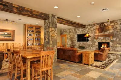 a living room with a table and a fireplace at Black Bear 8078 in Keystone