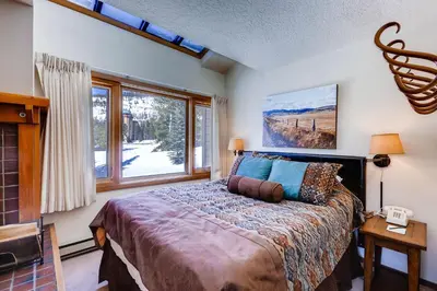 a bedroom with a bed and a large window at Lenawee 1747 in Keystone