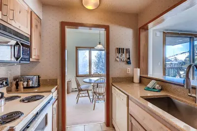 a kitchen with a view of a dining room at Lenawee 1747 in Keystone