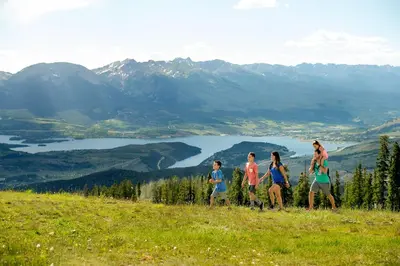 a group of people walking on top of a hill at Lenawee 1747 in Keystone