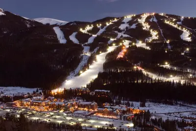 a ski resort at night with lights on a mountain at Lenawee 1747 in Keystone