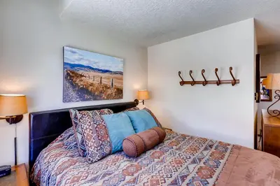 a bedroom with a bed and a painting on the wall at Lenawee 1747 in Keystone