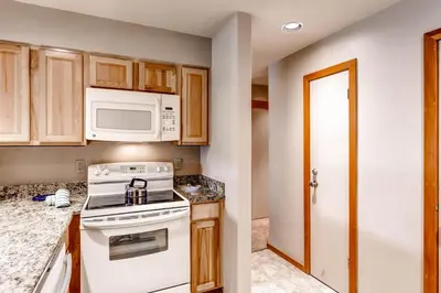 a kitchen with a stove and a microwave at Quicksilver 1643 in Keystone