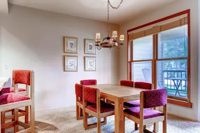a dining room with a wooden table and chairs at Quicksilver 1643 in Keystone