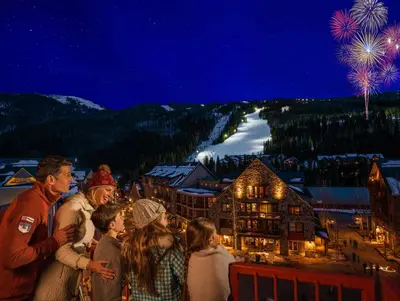 a group of people standing on top of a building at night at Quicksilver 1643 in Keystone