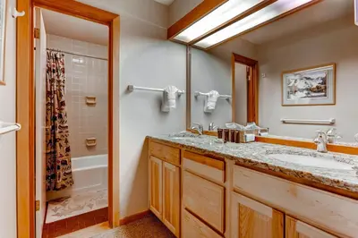 a bathroom with a sink and a shower and a tub at Quicksilver 1643 in Keystone