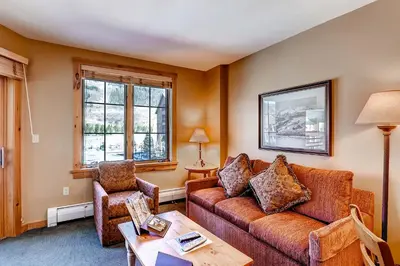 a living room with a couch and a chair at Dakota Lodge 8513 in Keystone