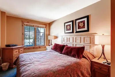 a bedroom with a large bed and a window at Dakota Lodge 8513 in Keystone