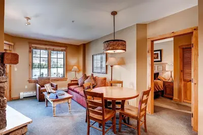 a living room with a table and a couch at Dakota Lodge 8513 in Keystone