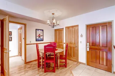 a dining room with a table and red chairs at Gateway 5069 in Keystone