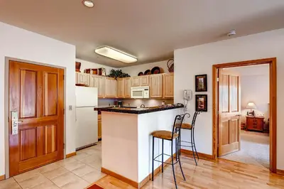 a kitchen with a white refrigerator and a counter at Gateway 5069 in Keystone