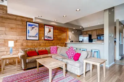 a living room with a couch and a kitchen at Plaza 1407 in Keystone