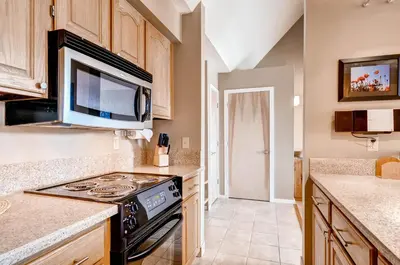 a kitchen with a stove and a microwave at Plaza 1407 in Keystone