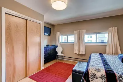 a bedroom with a bed and a dresser and a window at Plaza 1407 in Keystone