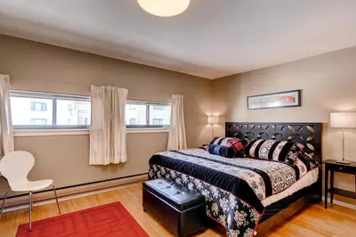 a bedroom with a bed and two windows at Plaza 1407 in Keystone
