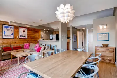a living room with a table and a couch at Plaza 1407 in Keystone