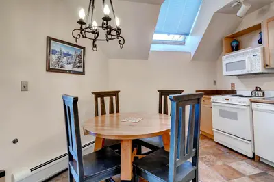 a kitchen with a wooden table and some chairs at Silver Mill 8289 in Keystone