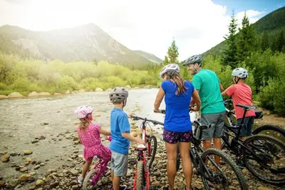 a group of people with bikes on a river at Silver Mill 8289 in Keystone