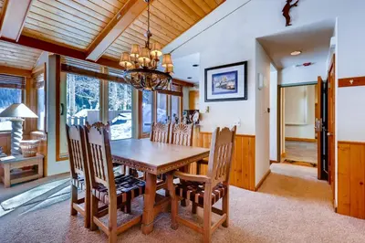 a dining room with a wooden table and chairs at Decatur 1775 in Keystone