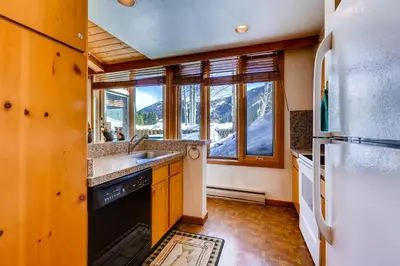 a kitchen with a sink and a refrigerator at Decatur 1775 in Keystone