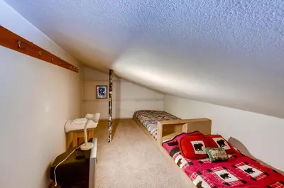 a bedroom with two bunk beds and a bed with a red blanket at Decatur 1775 in Keystone