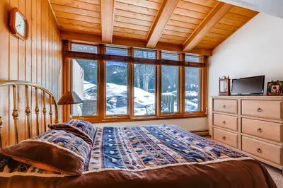 a bedroom with a bed and a large window at Decatur 1775 in Keystone