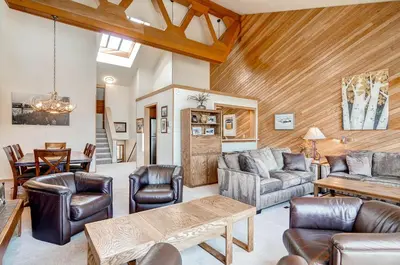 a living room with leather furniture and a wooden ceiling at Lenawee 1735 in Keystone