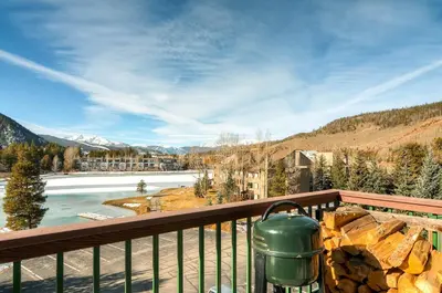 a view from a balcony of a river and mountains at Lenawee 1735 in Keystone