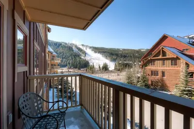 a balcony with a bench looking out at a ski slope at Red Hawk 2272 in Keystone