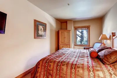 a bedroom with a bed and a window at Red Hawk 2272 in Keystone