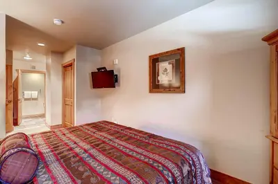 a bedroom with a bed and a tv on the wall at Red Hawk 2272 in Keystone