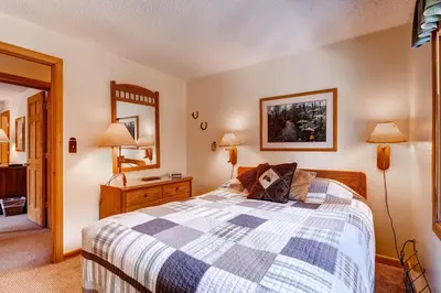 a bedroom with a bed and a mirror at Key Condo 2950 in Keystone