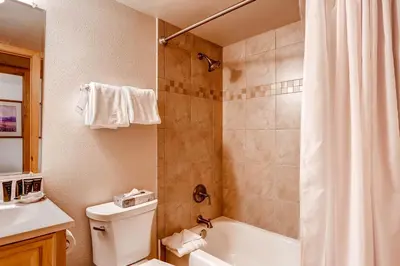 a bathroom with a shower and a toilet and a sink at Key Condo 2950 in Keystone