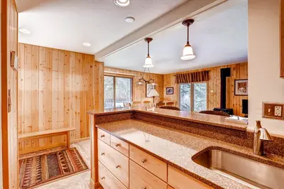 a kitchen with wooden walls and a large counter top at Key Condo 2950 in Keystone