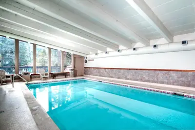 a swimming pool with blue water in a building with windows at Key Condo 2950 in Keystone