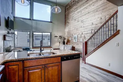 a kitchen with a sink and a brick wall at Mall 1424 in Keystone