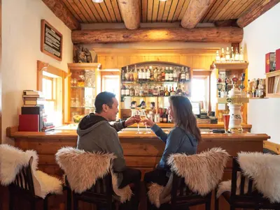 a man and a woman sitting at a bar at Mall 1424 in Keystone