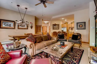 a living room with a couch and a table at Timbers 3060 in Keystone