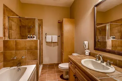 a bathroom with a sink and a toilet and a tub at Timbers 3060 in Keystone
